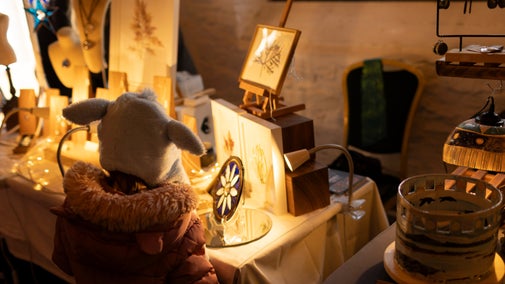 A young visitor looks at stalls in the Christmas market